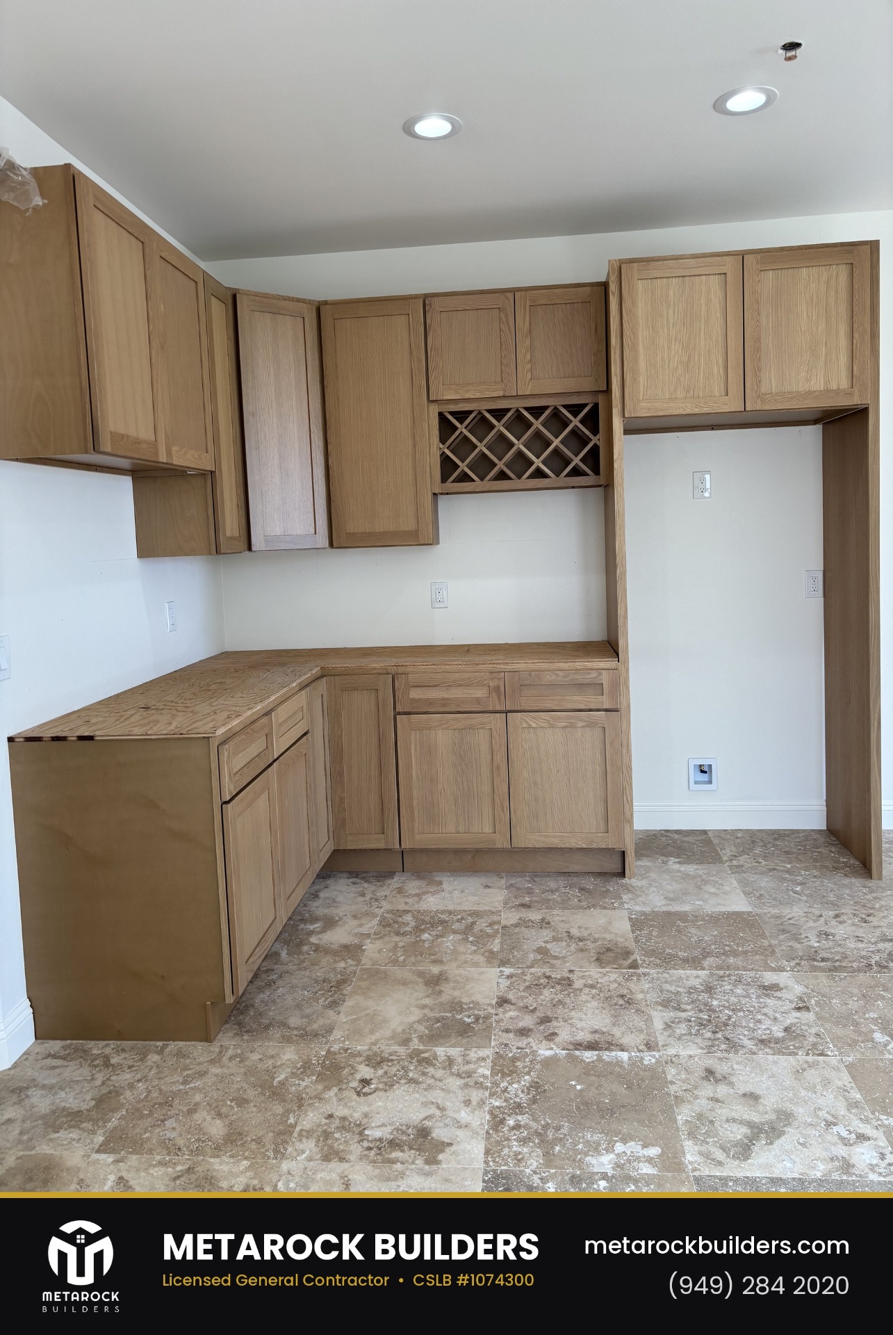 Kitchen remodel in Orange County by Metarock Builders, completed after photo with natural oak shaker cabinetry, wine lattice, and travertine tile floor