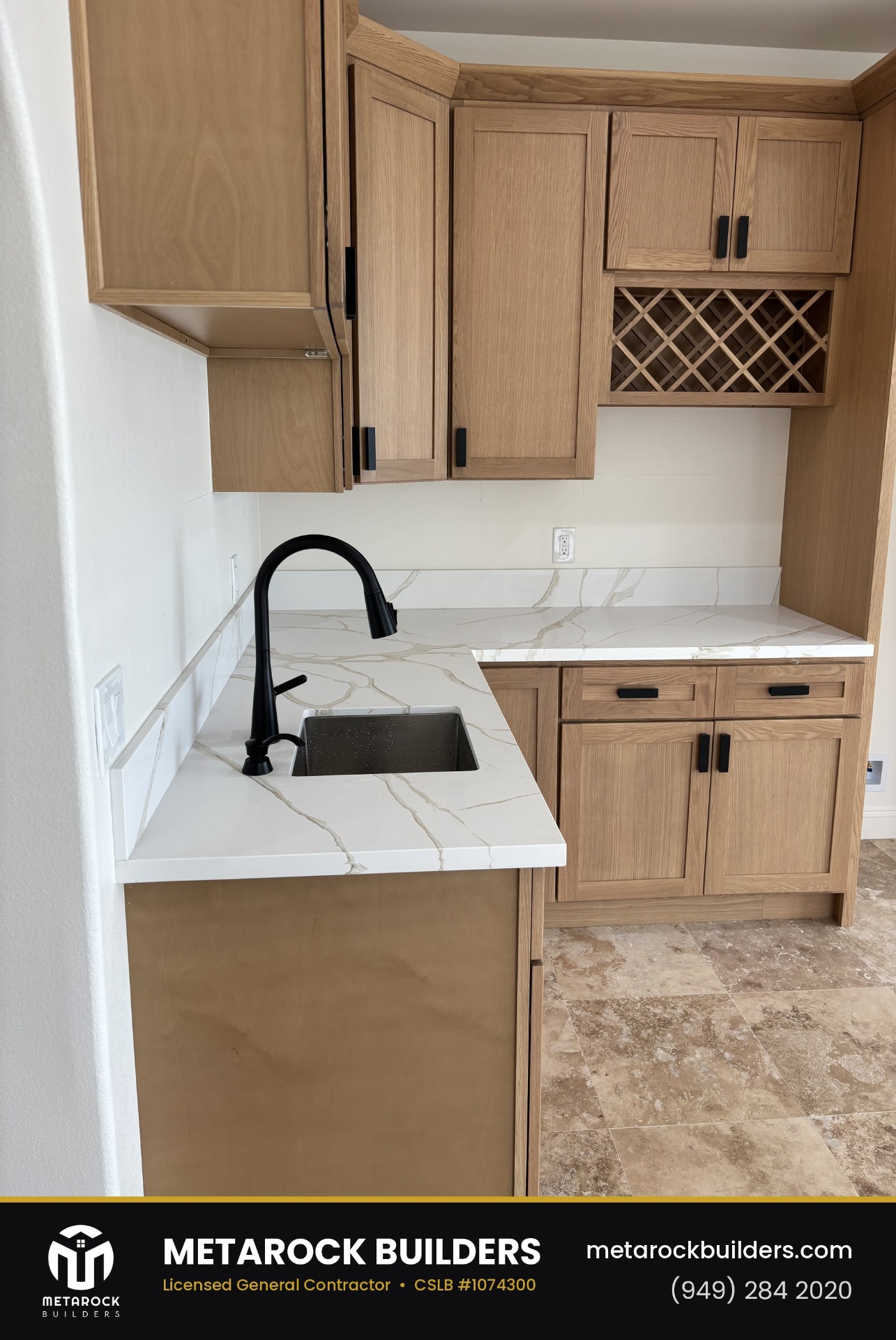 Kitchen remodel in Orange County by Metarock Builders, completed after photo with calacatta quartz counters, matte black faucet, and oak cabinetry