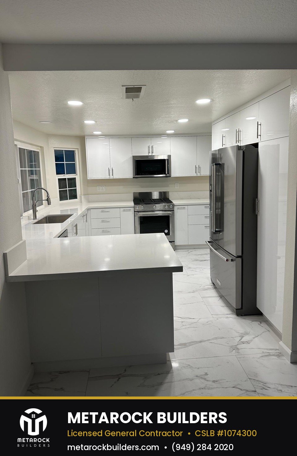 Kitchen remodel in Orange County by Metarock Builders, completed after photo with white cabinetry, quartz counters, and marble-look tile floor