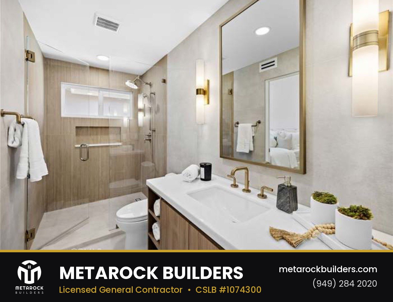 Bathroom remodel in Orange County by Metarock Builders, completed after photo with wood-look tile shower, floating oak vanity, brushed brass fixtures, and framed mirror
